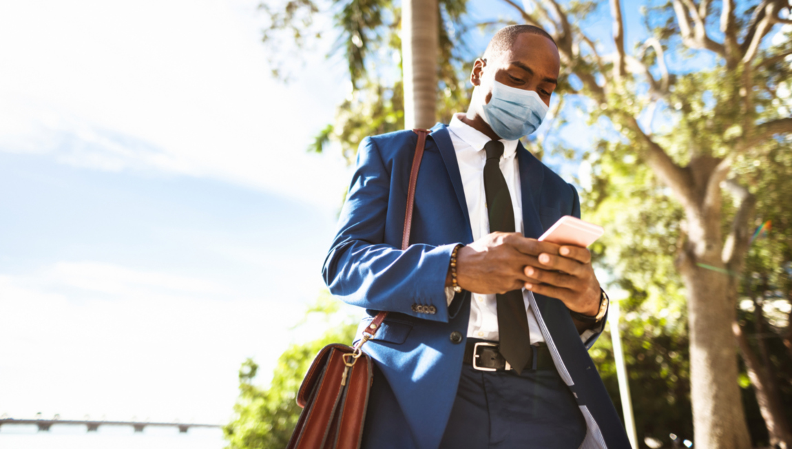 business_man_walking_holding_phone